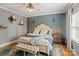Comfortable main bedroom with decorative pillows, sconces, and natural light at 2217 Yadkin Ave, Charlotte, NC 28205
