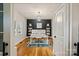 Bright home office with hardwood floors, custom shelving, and an accent wall at 2217 Yadkin Ave, Charlotte, NC 28205