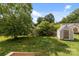 Spacious backyard with green grass and a shed, perfect for outdoor activities at 252 Sweet Bay Nw Ln, Concord, NC 28027