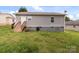 Backyard with a deck, grassy area, and exterior of the home with neutral siding at 252 Sweet Bay Nw Ln, Concord, NC 28027