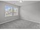 Bright bedroom with large windows, providing ample natural light and a cozy carpeted floor at 252 Sweet Bay Nw Ln, Concord, NC 28027