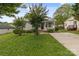 A charming home with gray siding, a well-manicured lawn, and a long driveway at 252 Sweet Bay Nw Ln, Concord, NC 28027