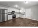 Updated kitchen featuring white cabinets, stainless steel appliances, and dark countertops at 252 Sweet Bay Nw Ln, Concord, NC 28027