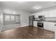 Bright kitchen with white cabinets, stainless steel appliances, vinyl floors, and an open layout at 252 Sweet Bay Nw Ln, Concord, NC 28027