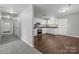 Modern kitchen with white cabinets, dark countertops, stainless steel appliances, and hardwood flooring at 252 Sweet Bay Nw Ln, Concord, NC 28027