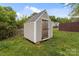 A backyard storage shed with siding and wooden door at 252 Sweet Bay Nw Ln, Concord, NC 28027