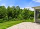 Brick patio in a backyard overlooking a dense wooded area at 3009 Lydney Cir, Waxhaw, NC 28173