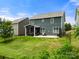 Large backyard featuring green grass, a patio, and an enclosed porch, creating a private retreat at 3009 Lydney Cir, Waxhaw, NC 28173