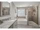 Stylish bathroom with granite countertops, a shower, and a soaking tub under a window at 3009 Lydney Cir, Waxhaw, NC 28173