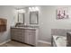 Bathroom with a granite countertop vanity, modern fixtures, and a soaking tub at 3009 Lydney Cir, Waxhaw, NC 28173