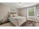 Cozy bedroom showcasing hardwood floors, bright natural light, and neutral paint tones at 3009 Lydney Cir, Waxhaw, NC 28173