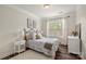 Comfortable bedroom with a decorative bed frame, floral bedding, and a bright window at 3009 Lydney Cir, Waxhaw, NC 28173