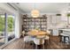 Bright dining area with a modern light fixture, dining table, and access to the outdoor living space at 3009 Lydney Cir, Waxhaw, NC 28173
