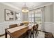 Bright dining room featuring wainscoting, a large window, and a stylish chandelier at 3009 Lydney Cir, Waxhaw, NC 28173