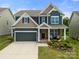 Beautiful two-story home with a manicured lawn, covered porch, and a two-car garage at 3009 Lydney Cir, Waxhaw, NC 28173