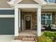 Inviting front porch with stone accents and a 'welcome' sign, offering a cozy seating area at 3009 Lydney Cir, Waxhaw, NC 28173