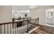 Hallway featuring hardwood floors, wood railing, and access to other living spaces at 3009 Lydney Cir, Waxhaw, NC 28173