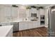 Well-equipped kitchen with white cabinets, stainless steel appliances, and hardwood floors at 3009 Lydney Cir, Waxhaw, NC 28173
