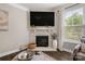 Cozy living room featuring a stone fireplace with a large TV mounted above the mantle at 3009 Lydney Cir, Waxhaw, NC 28173