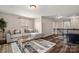 Upstairs bonus living area features modern sofa, striped rug, and plenty of natural light at 3009 Lydney Cir, Waxhaw, NC 28173