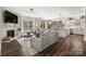Open-concept living room with a fireplace, hardwood floors, and a view of the kitchen at 3009 Lydney Cir, Waxhaw, NC 28173