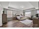 Main bedroom with tray ceiling, hardwood floors, and natural light at 3009 Lydney Cir, Waxhaw, NC 28173