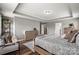 Spacious bedroom features a tray ceiling, hardwood floors, and stylish furniture at 3009 Lydney Cir, Waxhaw, NC 28173