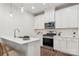 Modern kitchen features white cabinetry, stainless steel appliances, and sleek countertops at 3034 Finchborough Ct # 233, Charlotte, NC 28269
