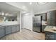 The kitchen area has gray cabinets, stainless appliances, a pantry closet and is adjoined to the living room at 3071 Des Prez Ave, Fort Mill, SC 29707
