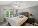 Vaulted ceiling bedroom has a large window, a ceiling fan and is accented by a soothing color palette at 3071 Des Prez Ave, Fort Mill, SC 29707