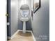 The powder room showcases modern fixtures and a pedestal sink with a round mirror above it at 3071 Des Prez Ave, Fort Mill, SC 29707