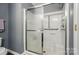 Bathroom with a walk in shower featuring sleek glass doors and neutral finishes at 3071 Des Prez Ave, Fort Mill, SC 29707