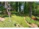 A meticulously kept backyard with mature trees and lush, established landscaping and a backyard fence at 308 Odell St, Kannapolis, NC 28083