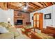 Finished basement featuring a brick fireplace, exposed ceiling, and a comfortable seating arrangement at 308 Odell St, Kannapolis, NC 28083