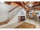 Finished basement area featuring painted block walls, exposed ceiling, and staircase to the upper level at 308 Odell St, Kannapolis, NC 28083