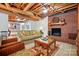 Finished basement featuring a brick fireplace, exposed ceiling, and a comfortable seating arrangement at 308 Odell St, Kannapolis, NC 28083