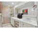 Bathroom featuring double sinks, white cabinets, and a tiled glass-enclosed shower at 308 Odell St, Kannapolis, NC 28083