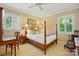 Bedroom with a wooden four-poster bed, natural lighting, and a cozy feel at 308 Odell St, Kannapolis, NC 28083