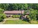 Ranch-style brick house with manicured shrubs and beautiful mature tree at 308 Odell St, Kannapolis, NC 28083