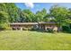 Charming brick home with a well-manicured lawn and mature landscaping at 308 Odell St, Kannapolis, NC 28083