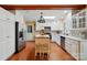 Bright eat-in kitchen featuring white cabinets, hardwood floors and stainless steel appliances at 308 Odell St, Kannapolis, NC 28083