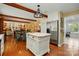 Kitchen with hardwood floors, white cabinets, stainless appliances, and open floor plan to dining at 308 Odell St, Kannapolis, NC 28083