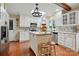 Well-lit eat-in kitchen with stainless appliances, white cabinets, hardwood floors and island at 308 Odell St, Kannapolis, NC 28083