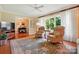 Bright living room with hardwood floors, two chairs, large windows and view into adjacent dining room at 308 Odell St, Kannapolis, NC 28083