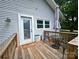 Outdoor deck featuring a table, chairs, and an umbrella, providing a comfortable and shaded seating area at 329 Highland Dr, Lincolnton, NC 28092