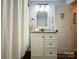 Cozy bathroom with white vanity, granite countertop, and a shower with a white curtain at 329 Highland Dr, Lincolnton, NC 28092