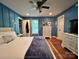 Bedroom with board and batten walls, hardwood floors, and a comfortable bed with a plush blue throw at 329 Highland Dr, Lincolnton, NC 28092