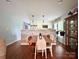 Open dining area features a stone accent wall, pendant lights, and hardwood floors adjacent to the kitchen at 329 Highland Dr, Lincolnton, NC 28092