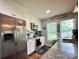 Bright kitchen with stainless steel appliances, granite countertops, tile backsplash, and ample natural light from the windows at 329 Highland Dr, Lincolnton, NC 28092