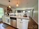 Kitchen featuring stainless appliances, a sink, granite counters, and white cabinets open to living and dining area at 329 Highland Dr, Lincolnton, NC 28092